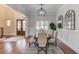 Dining room featuring elegant finishes, hardwood flooring, wainscoting and lots of natural light at 5394 Brendlynn Dr, Suwanee, GA 30024