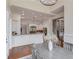 Bright dining room with hardwood floors, modern chandelier, and views into the kitchen at 5394 Brendlynn Dr, Suwanee, GA 30024