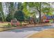 Charming brick entrance to Edinburgh neighborhood with manicured landscaping and mature trees at 5394 Brendlynn Dr, Suwanee, GA 30024