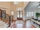 Bright foyer with high ceilings, detailed millwork, and a view of the double front doors and formal dining room at 5394 Brendlynn Dr, Suwanee, GA 30024