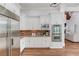 Gourmet kitchen with white cabinetry, stainless steel appliances, and hardwood floors at 5394 Brendlynn Dr, Suwanee, GA 30024