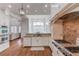 Gourmet kitchen features custom cabinets, granite countertops, stainless steel appliances, and hardwood floors at 5394 Brendlynn Dr, Suwanee, GA 30024