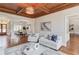 Open-concept living room flows into the dining area, featuring a coffered ceiling, hardwood floors, and ample seating at 5394 Brendlynn Dr, Suwanee, GA 30024