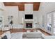 Cozy living room with vaulted wood ceiling, a stone fireplace, and French doors to a patio at 5394 Brendlynn Dr, Suwanee, GA 30024