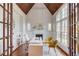 Bright home office with vaulted wood ceiling, modern desk, fireplace, and large windows at 5394 Brendlynn Dr, Suwanee, GA 30024