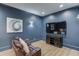 Home theater room with reclining leather seats, a big screen tv, and elegant blue color scheme at 5394 Brendlynn Dr, Suwanee, GA 30024