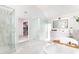 Bright bathroom with a glass shower, modern vanity, and freestanding tub with a view at 85 Cliffside Crossing, Atlanta, GA 30350