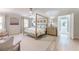 Spacious bedroom featuring a four-poster bed, neutral tones, and a view to a bright open doorway at 85 Cliffside Crossing, Atlanta, GA 30350