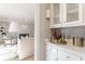 Butlers pantry with cabinets, storage for glassware and bar items, and a view into the living room at 85 Cliffside Crossing, Atlanta, GA 30350