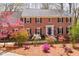 Charming two-story brick home featuring manicured landscaping with vibrant azaleas in a beautiful yard at 85 Cliffside Crossing, Atlanta, GA 30350