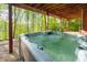 Outdoor hot tub with wooded views, providing a serene and private relaxation space at 85 Cliffside Crossing, Atlanta, GA 30350