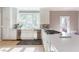 Bright kitchen featuring white cabinets, stainless steel appliances, and natural light from a large window at 85 Cliffside Crossing, Atlanta, GA 30350