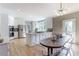 Bright eat-in kitchen with stainless steel appliances, center island, and clear acrylic dining set at 85 Cliffside Crossing, Atlanta, GA 30350