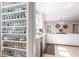 White kitchen with custom spice rack, stainless steel appliances, and stone countertops at 85 Cliffside Crossing, Atlanta, GA 30350