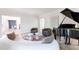 Elegant living room featuring a grand piano, plush seating, and open access to other living spaces at 85 Cliffside Crossing, Atlanta, GA 30350