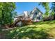 Expansive backyard features a large wooden deck, lush lawn, and mature trees at 1107 Fieldstone Dr, Canton, GA 30114