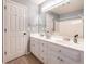 This bathroom features a large vanity with double sinks, bright lighting, and a large, framed mirror at 1107 Fieldstone Dr, Canton, GA 30114