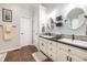 This bright bathroom offers double sinks with dark fixtures, decorative mirrors, and stylish wall accents at 1107 Fieldstone Dr, Canton, GA 30114