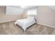 This bedroom offers a bed with bright, white linens in a room with neutral colors and angled ceiling at 1107 Fieldstone Dr, Canton, GA 30114