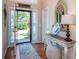 The home entryway features an open door, a decorative table, and a view of the landscaped front yard at 1107 Fieldstone Dr, Canton, GA 30114