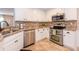 Modern kitchen featuring stainless steel appliances, tile backsplash, and white cabinetry at 1107 Fieldstone Dr, Canton, GA 30114