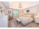 This inviting main bedroom features a tray ceiling, neutral décor, and a decorative chandelier at 1107 Fieldstone Dr, Canton, GA 30114