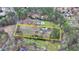 An aerial view of the property showing the generous land, multiple structures, and surrounding trees at 1880 Ridgedale Dr, Snellville, GA 30078