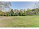 Expansive backyard features a mix of green grass and trees at 1880 Ridgedale Dr, Snellville, GA 30078