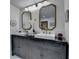 Stylish bathroom with double vanity, framed mirrors, brushed gold faucets and elegant decor at 1880 Ridgedale Dr, Snellville, GA 30078