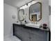 Bathroom with double vanity, vessel sinks, modern fixtures, and decorative mirrors at 1880 Ridgedale Dr, Snellville, GA 30078