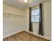 Walk-in closet with wooden floors, shelving, window and natural lighting at 1880 Ridgedale Dr, Snellville, GA 30078