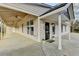 Covered front porch with fans and an entrance with potted flowers outside and the house number 1880 at 1880 Ridgedale Dr, Snellville, GA 30078
