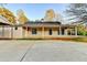 Rear exterior view of the home with a large parking area and covered patio at 1880 Ridgedale Dr, Snellville, GA 30078