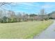A large, green front lawn with scattered trees creates a peaceful and inviting atmosphere at 1880 Ridgedale Dr, Snellville, GA 30078
