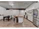 Eat-in kitchen features a dining table, an island with seating, and stainless steel appliances at 1880 Ridgedale Dr, Snellville, GA 30078