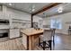 Kitchen with stainless steel appliances, a wooden island, open shelving, and white cabinetry at 1880 Ridgedale Dr, Snellville, GA 30078