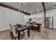 Well-lit kitchen boasts stainless steel appliances, island with seating, and nearby dining table at 1880 Ridgedale Dr, Snellville, GA 30078