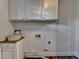 Laundry room with granite counters, stone sink, storage cabinets and utility connections at 1880 Ridgedale Dr, Snellville, GA 30078