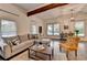 Bright living room with comfortable furniture and wood beam ceilings bringing together natural light and charm at 1880 Ridgedale Dr, Snellville, GA 30078