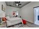 Comfortable bedroom with soft lighting, ceiling fan, and an adjoining sitting area at 1880 Ridgedale Dr, Snellville, GA 30078