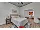 Well-lit bedroom featuring a ceiling fan, ample space, and a charming seating area at 1880 Ridgedale Dr, Snellville, GA 30078