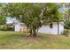 A picturesque backyard with a mature tree, lush lawn, and updated home exterior at 2297 Sheryl Dr, Decatur, GA 30032