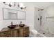 This bathroom features a double sink vanity, tiled shower, and modern fixtures and lighting at 2297 Sheryl Dr, Decatur, GA 30032