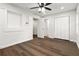 An empty bedroom featuring wood floors, ceiling fan, brick accent wall, closet and two entry doors at 2297 Sheryl Dr, Decatur, GA 30032
