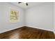 Standard bedroom design with wood floors, ceiling fan, and a window for natural lighting at 2297 Sheryl Dr, Decatur, GA 30032