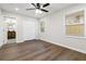 A standard bedroom featuring wood floors, ceiling fan, closet and two windows to let in the natural light at 2297 Sheryl Dr, Decatur, GA 30032