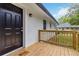 Inviting front entrance with a dark door, wooden porch, and painted brick at 2297 Sheryl Dr, Decatur, GA 30032