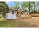 Charming white home with a welcoming wooden front porch and freshly painted white brick foundation at 2297 Sheryl Dr, Decatur, GA 30032