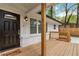 Charming front porch featuring stained wood and brick accents and a new front door at 2297 Sheryl Dr, Decatur, GA 30032
