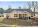 Charming backyard featuring a covered patio, outdoor seating, and a beautifully maintained lawn and garden at 338 Rc Thompson Rd, Dallas, GA 30157